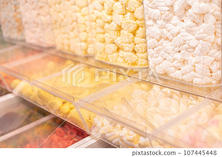 Pastel yellow marshmallows in a shop window Pastel yellow marshmallows in a shop window 107445448