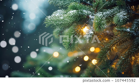 Pine tree branches with lights decoration on blurred falling snow background 107445592