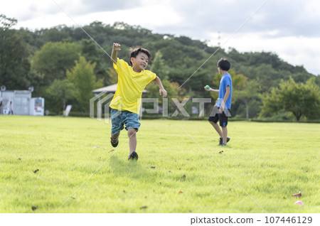 boy running around in the park boy running around in the park 107446129