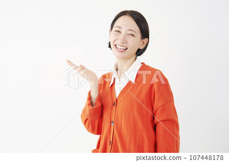 Woman pointing to the left with her palm, white background Woman pointing to the left with her palm, white background 107448178