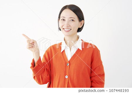 Woman pointing to the left, white background 107448193