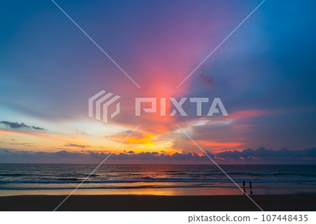 amazing pink sky above Karon beach Phuket at colorful sunset. sweet sky in colorful sunset above the ocean. Imagine a fantasy bright pink in blue sky at sunset. Sky texture background. 107448435