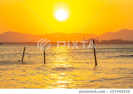 scenery reflection of the sun in golden sky at sunset. scenery reflection of the sun in golden sky at sunset. 107448439