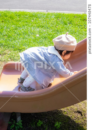 A child who wants to climb the slide A child who wants to climb the slide 107448478