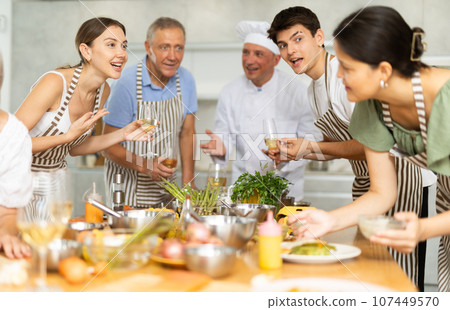 Group of people talking and drinking after master class 107449570