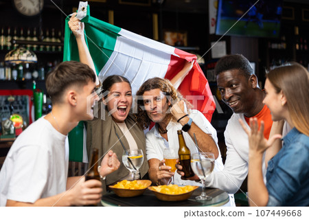 Excited sports fans celebrating victory of favorite Italian team in bar 107449668