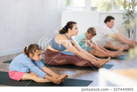 Family with two children doing pilates in studio Family with two children doing pilates in studio 107449905