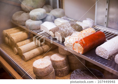 Delicious goat cheese on the supermarket showcase Delicious goat cheese on the supermarket showcase 107449948