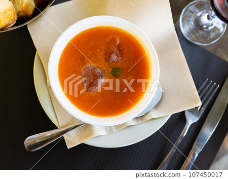 Close-up of tomato gazpacho soup in bowl topped with ice cubes Close-up of tomato gazpacho soup in bowl topped with ice cubes 107450017