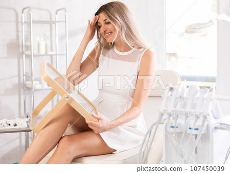 woman can see results of cosmetic 107450039