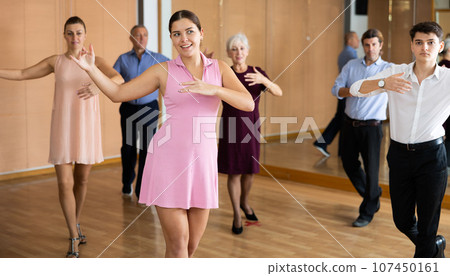 Couple of young dancers rehearsing ballroom dances in dance studio 107450161