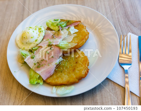 Belarusian potato draniki with fried egg, bacon 107450193