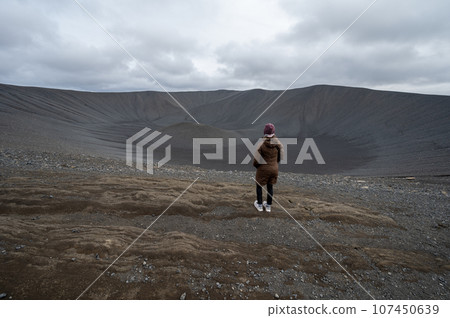 Woman enjoying view from rim into Hverfjall crater east of Myvatn, Iceland. Woman enjoying view from rim into Hverfjall crater east of Myvatn, Iceland. 107450639