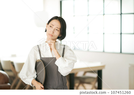 A clerk thinking at a cafe A clerk thinking at a cafe 107451260