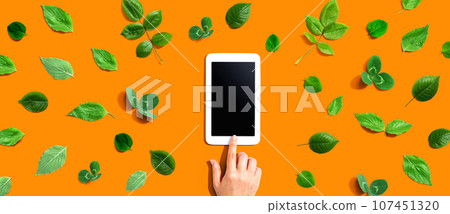 Green leaves with a tablet compute Green leaves with a tablet compute 107451320