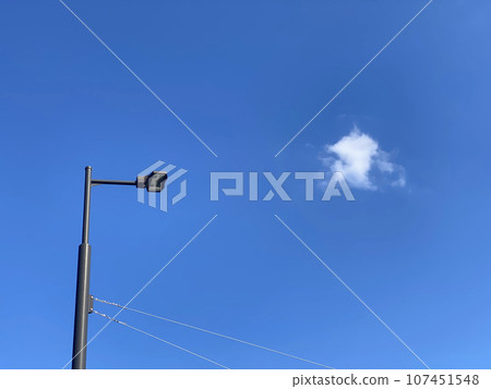 Telephone poles and wires under the blue sky 107451548