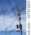 Telephone poles and wires under the blue sky 107451605