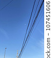 Telephone poles and wires under the blue sky 107451606