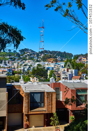 Large neighborhood on hill going up to Sutro Tower on blue sky day 107451832