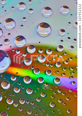 Laser burst of rainbow light across reflective metallic surface with bubbles abstract asset Laser burst of rainbow light across reflective metallic surface with bubbles abstract asset 107452122