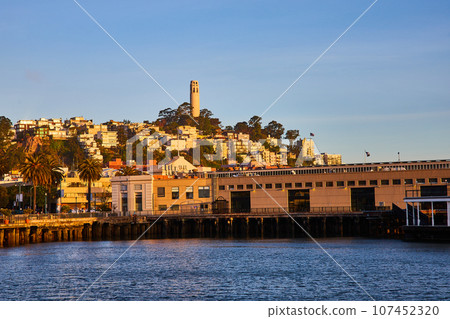 San Francisco Bay view looking at shoreline and Coit Tower on hill near sunset San Francisco Bay view looking at shoreline and Coit Tower on hill near sunset 107452320