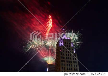 Red and white fireworks lighting up night sky behind Lincoln Tower on 4th of July 107452338