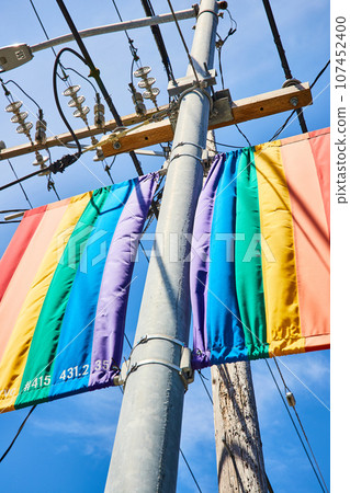 Close up view of LGBTQIA+ rainbow banners on streetlight Close up view of LGBTQIA+ rainbow banners on streetlight 107452400