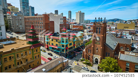 Colorful Chinatown buildings and church on blue sky day with partial clouds aerial Colorful Chinatown buildings and church on blue sky day with partial clouds aerial 107452585