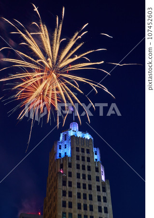 Downtown Fort Wayne Lincoln Tower with blue lights and golden 4th of July fireworks overhead Downtown Fort Wayne Lincoln Tower with blue lights and golden 4th of July fireworks overhead 107452603