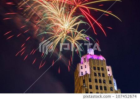 Red and green and gold 4th of July fireworks over purple lit Lincoln Tower close up in Fort Wayne 107452674