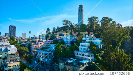 Aerial apartment buildings on Telegraph Hill with Coit Tower on sunny summer day 107452696
