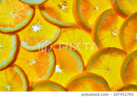 Wall of overlapping orange slices in background asset of citrus fruit Wall of overlapping orange slices in background asset of citrus fruit 107452705