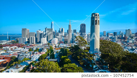 Aerial Telegraph Hill Coit Tower on blue sky day with downtown San Francisco skyscrapers Aerial Telegraph Hill Coit Tower on blue sky day with downtown San Francisco skyscrapers 107452754
