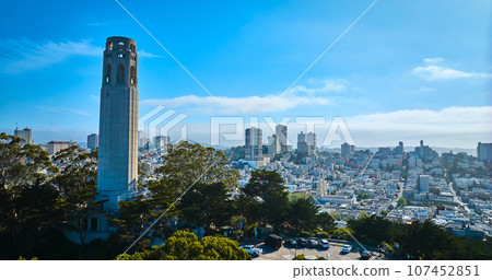 Aerial Coit Tower on Telegraph Hill with view of San Francisco city on blue sky day with clouds Aerial Coit Tower on Telegraph Hill with view of San Francisco city on blue sky day with clouds 107452851
