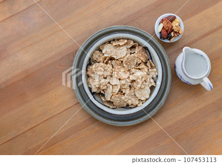Homemade Gadola, Cereal and Nuts in Ceramic bowl served with Almond milk on wooden table. Homemade Gadola, Cereal and Nuts in Ceramic bowl served with Almond milk on wooden table. 107453113