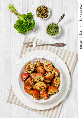 Herbs Garlic Potatoes in white bowl, top view Herbs Garlic Potatoes in white bowl, top view 107453498