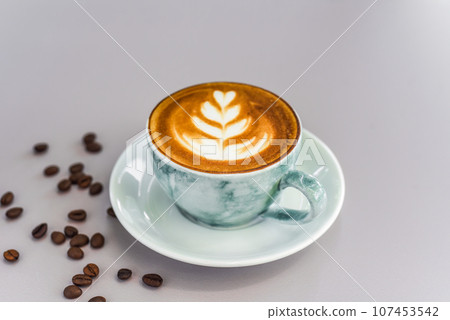 Cup of cappuccino with drawing on light gray background side view 107453542