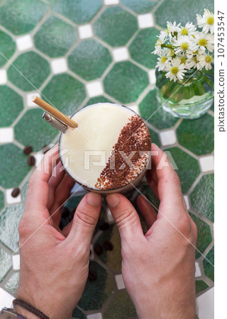Hands holding Vietnamese salted coffee with salty cheese cream (ca phe muoi) Hands holding Vietnamese salted coffee with salty cheese cream (ca phe muoi) 107453547