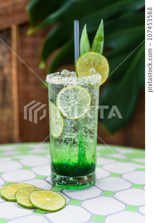 Panda leaves lemonade with desiccated coconut and green syrup on light gray background with copy space Panda leaves lemonade with desiccated coconut and green syrup on light gray background with copy space 107453568