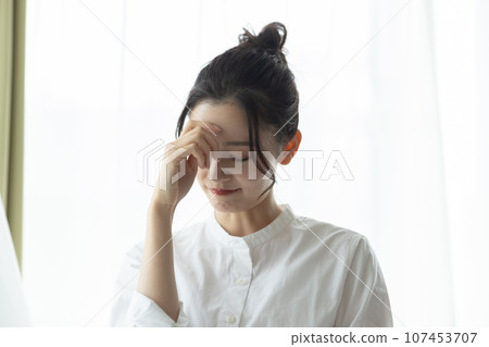 A woman with a headache A woman with a headache 107453707