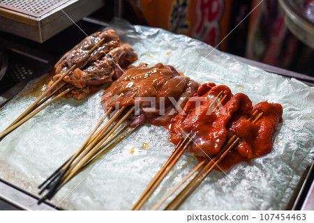Marinated raw meat on the sticks prepared for bbq in the Jalan Alor street food in Kuala Lumpur, Malaysia Marinated raw meat on the sticks prepared for bbq in the Jalan Alor street food in Kuala Lumpur, Malaysia 107454463