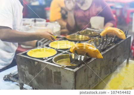 Apam Balik or Apom Balik traditional Malaysian pancake in Jalar Alor street food in Kuala Lumpur 107454482