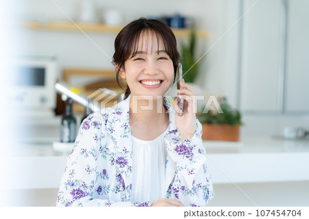 A young lady calling on a smartphone A young lady calling on a smartphone 107454704