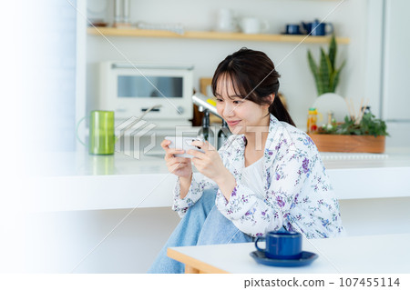 A young woman operating a smartphone A young woman operating a smartphone 107455114