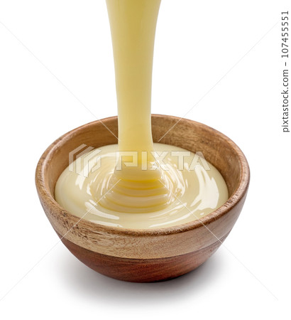 condensed milk pouring into bowl condensed milk pouring into bowl 107455551