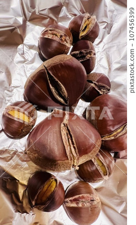 Roasted chestnuts on the dining table in a log house. Roasted chestnuts on the dining table in a log house. 107456399