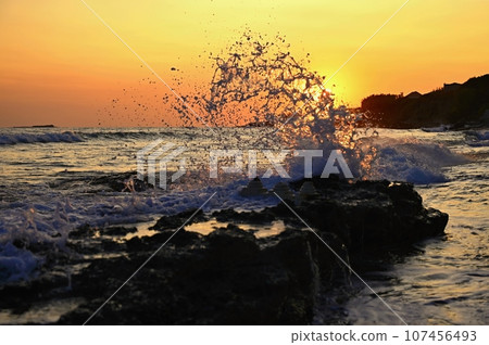 Beautiful sunset on the beach with the sea. Waves on the sea. Greece - Corfu island (Kerkyra) Agios Georgios. A concept for travel, holidays and summer vacations. Beautiful sunset on the beach with the sea. Waves on the sea. Greece - Corfu island (Kerkyra) Agios Georgios. A concept for travel, holidays and summer vacations. 107456493