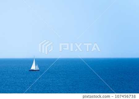 A sailing yacht sailing in a calm clear sky 107456738