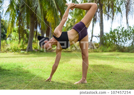 sugarcane pose or ardha chandra chapasana yoga with ukrainian woman making it outdoors sugarcane pose or ardha chandra chapasana yoga with ukrainian woman making it outdoors 107457254