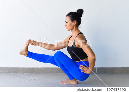 hand to big toe pose squat variation utthita hasta padangusthasana yoga with ukrainian woman making it indoors hand to big toe pose squat variation utthita hasta padangusthasana yoga with ukrainian woman making it indoors 107457290